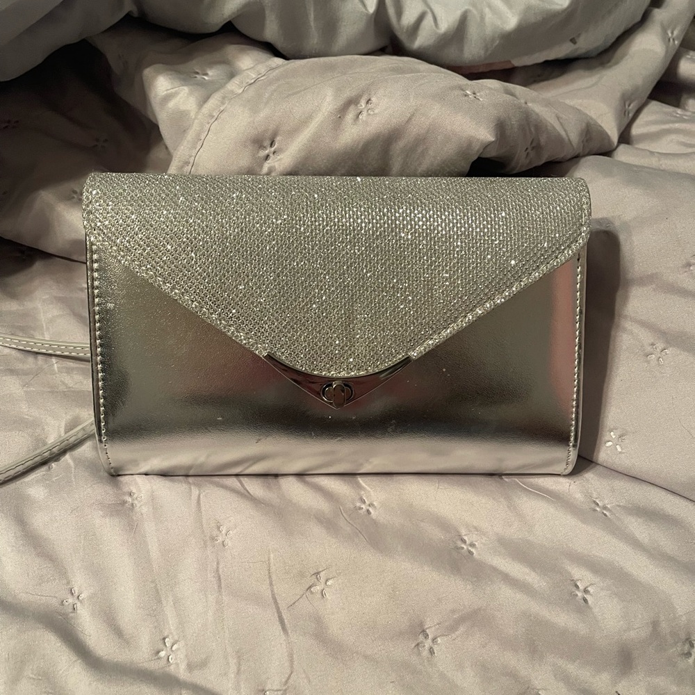 Silver Clutch Bag New W/O tags. 5 inches tall and 8 inches wide.